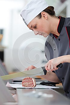 woman cutting meat