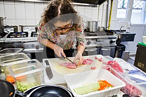 Woman cutting meat