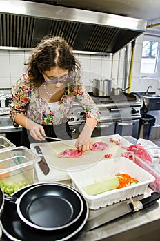 Woman cutting meat