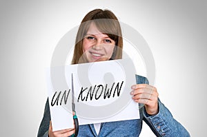 Woman cutting paper by scissors with unknown word