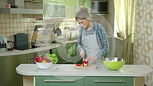 Woman cutting paprika.