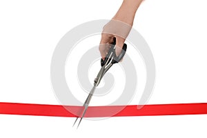 Woman cutting red ribbon with scissors on white background