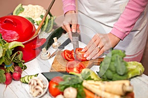 Woman cutting tomato