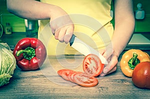 Woman cutting tomato for salad - retro style