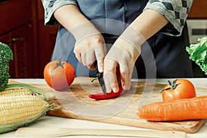 Woman cutting vegetables in her kitchen