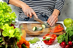 Woman cutting vegetables in the kitchen. Cooking healthy diet food concept.