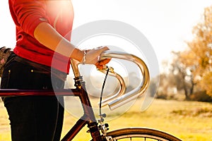 Woman cycling on bicycle in autumn park