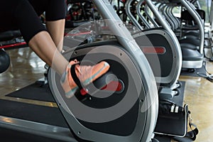 Woman cycling burn fat on bicycle cardio machine in fitness gym