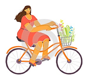 Woman cycling leisurely, enjoying sunny day. Female cyclist wears casual dress, rides orange bike photo