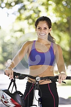 Woman Cycling Through Park