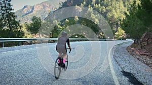 Woman cycling. Professional road cyclist riding bicycle at sunset. Triathlon and cycling concept. Sport motivation. Active healthy