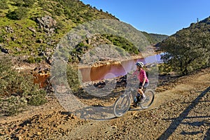 woman cycling at Rio Tinto, Andalusia, Spain