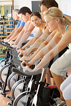 Woman Cycling In Spinning Class photo