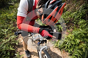 Woman cyclist have a rest with mobie phone