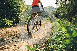 Woman cyclist riding mountain bike