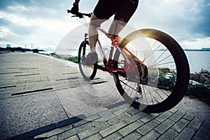 Woman cyclist riding Mountain Bike