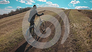 Woman cyclist riding mountain bike. Cycling along the forest road on sunny day. Adventure Lifestyle Concept.