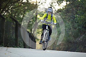 Woman cyclist riding mountain bike on forest trail