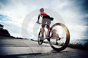 Woman cyclist riding Mountain Bike photo