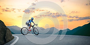 Woman Cyclist Riding Road Bike in the Beautiful Mountains at Sunset. Adventure, Healthy Lifestyle, Sport