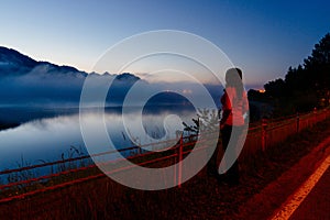 Woman at Czorsztyn Lake at dawn.