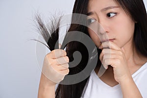 Woman with damaged hair on white background, closeup. Split ends