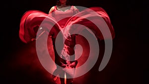 Woman dance of Argentine flamenco . Llight from behind. Smoke background. Slow motion