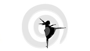 Woman dancer dancing contemporary dance and doing a split, on white, silhouette, slow motion