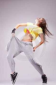 Woman dancer in a full of energy dance pose