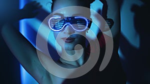 Woman dancer neon illuminated eyeglasses choreography show performance disco night party slowmo