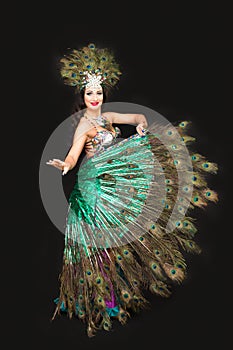 Woman dancer in peacock feather carniva