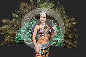 Woman dancer in peacock feather carniva