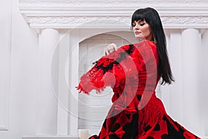 Woman dancer in red dress performing folk Gypsy dance