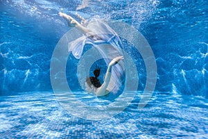 Woman dances under water.