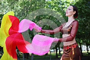 Woman dances with veil fans