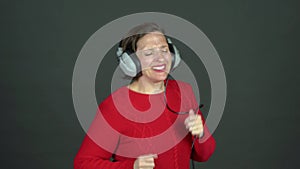 Woman dancing with Analog, corded headphones