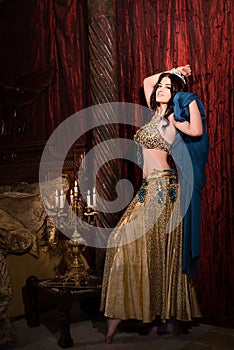 Woman dancing belly dance with shawl. Aesthetic of East