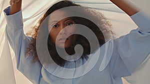 Woman dancing blowed fabric at sandy desert closeup. Performing dance with cloth