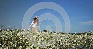 Woman dancing in a field of chamomiles
