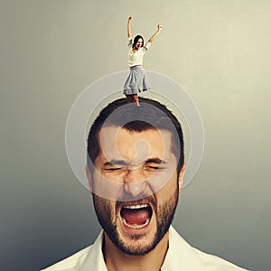 Woman dancing on the head of shouting man