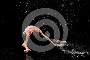 Woman dancing rain black background