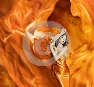 Woman dancing silk dress fire flame artistic orange burning blow