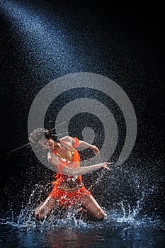 Woman dancing under rain