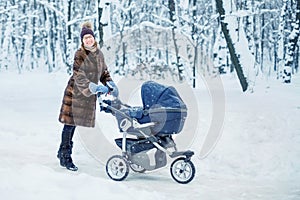 Woman dancing while winter walk with a stroller.