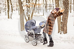 Woman dancing while winter walk with a stroller.