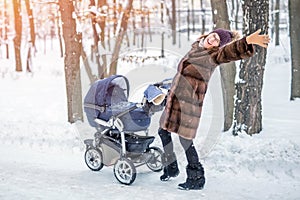 Woman dancing while winter walk with a stroller