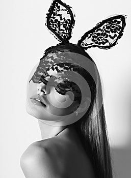 woman with dark har in bunny's mask