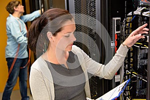 Woman datacenter manager in server room