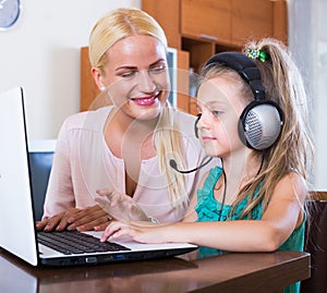 Woman and daughter chatting online