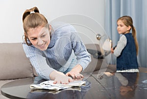 Woman with daughter cleaning house